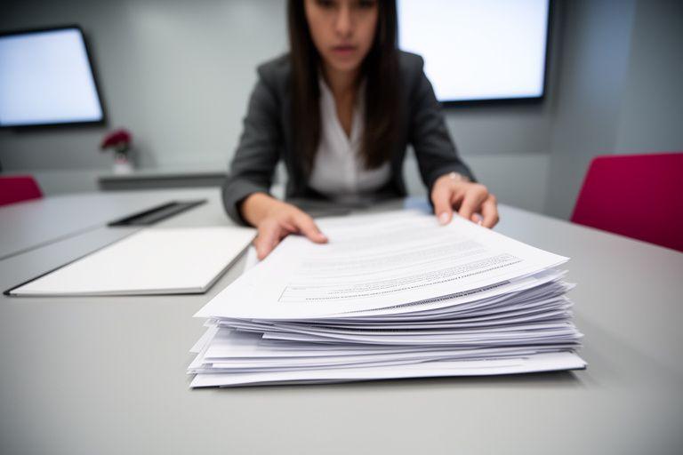 Commercial property manager examining a lease bundle in a modern meeting room